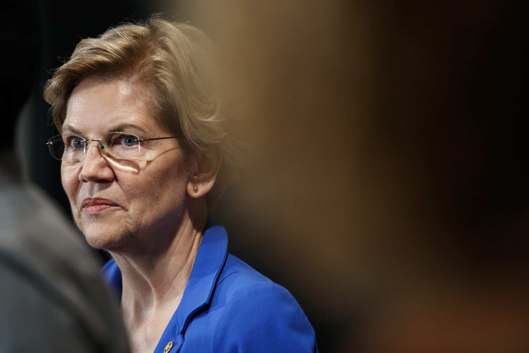 A close shot of Elizabeth Warren wearing a blue blouse.