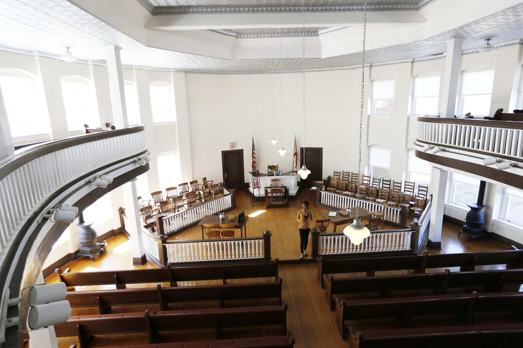 A woman stands in a courthouse.