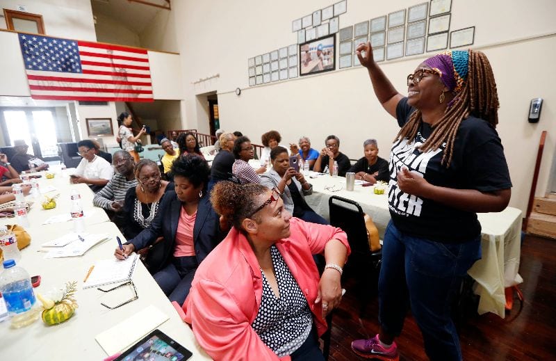 LaTosha Brown speaks to a crowd of women.