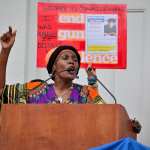 A woman speaks at a podium.