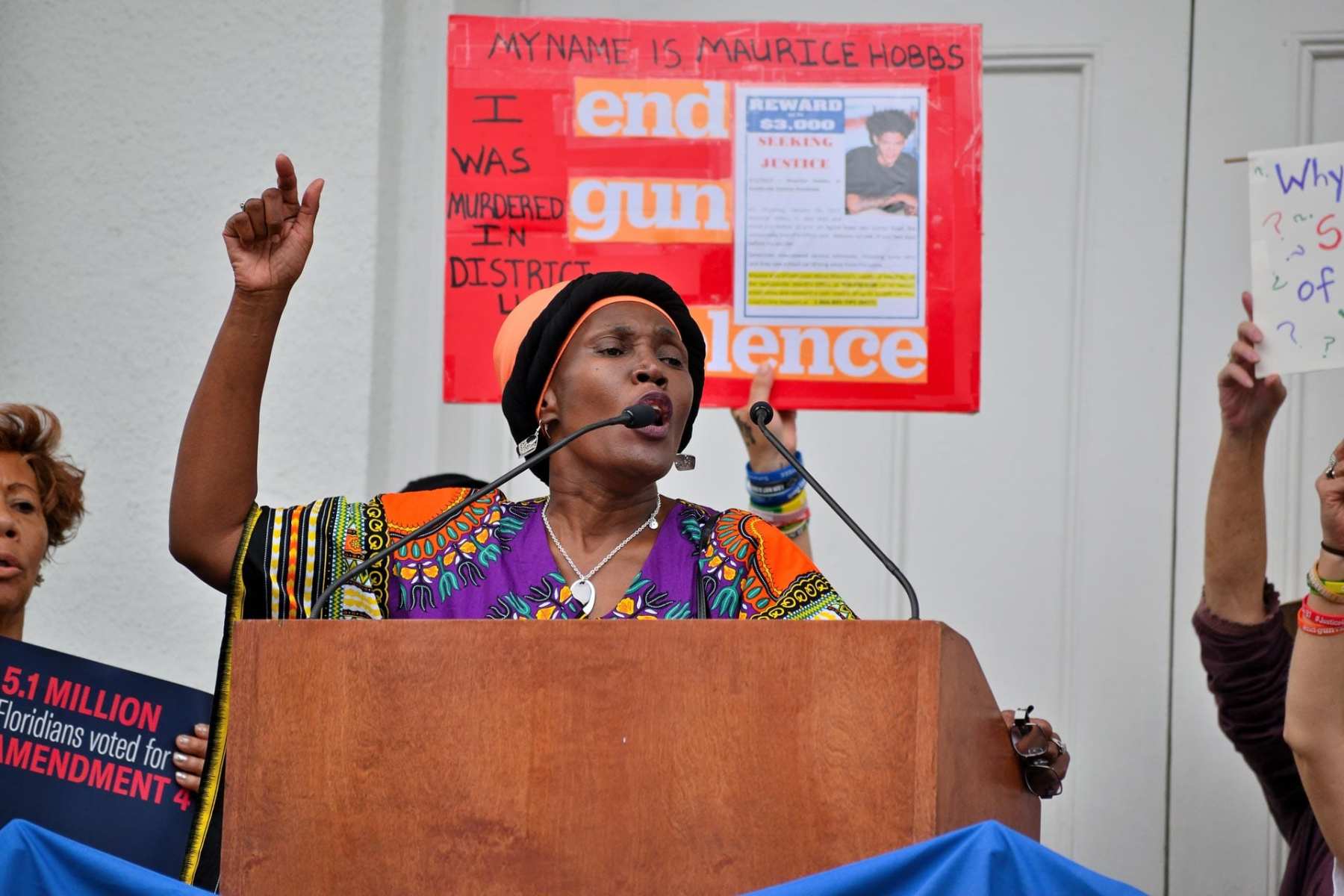 A woman speaks at a podium.