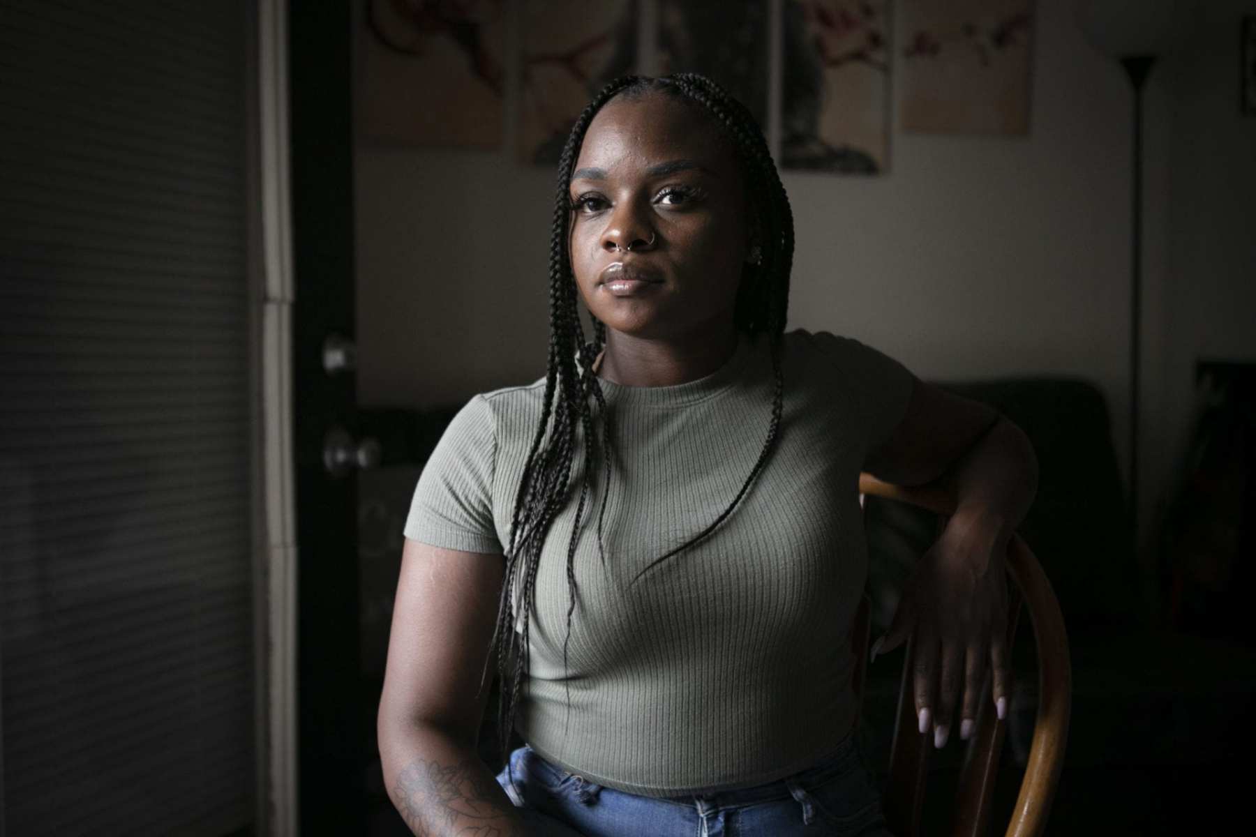 A woman sits in her apartment.