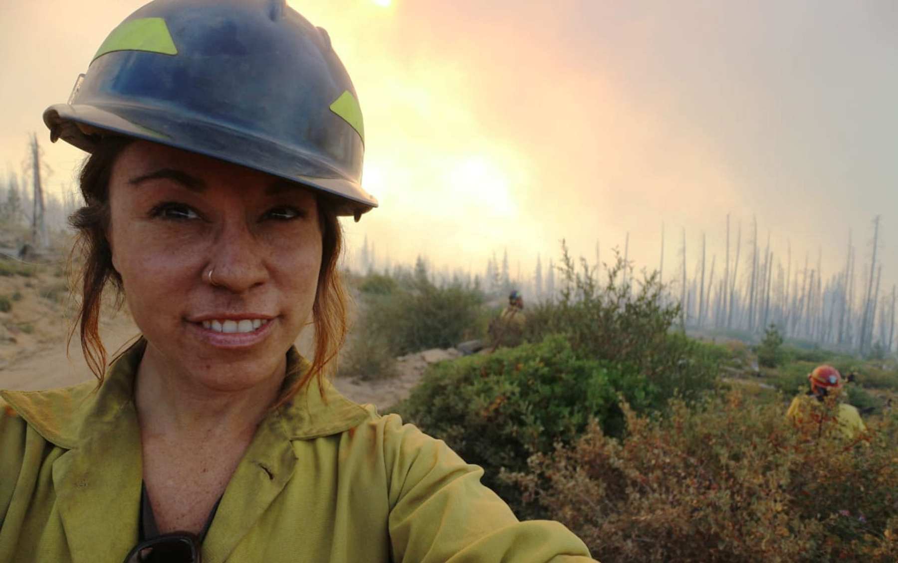 Eleonore Jordan Anderson takes a selfie in front of a landscape.