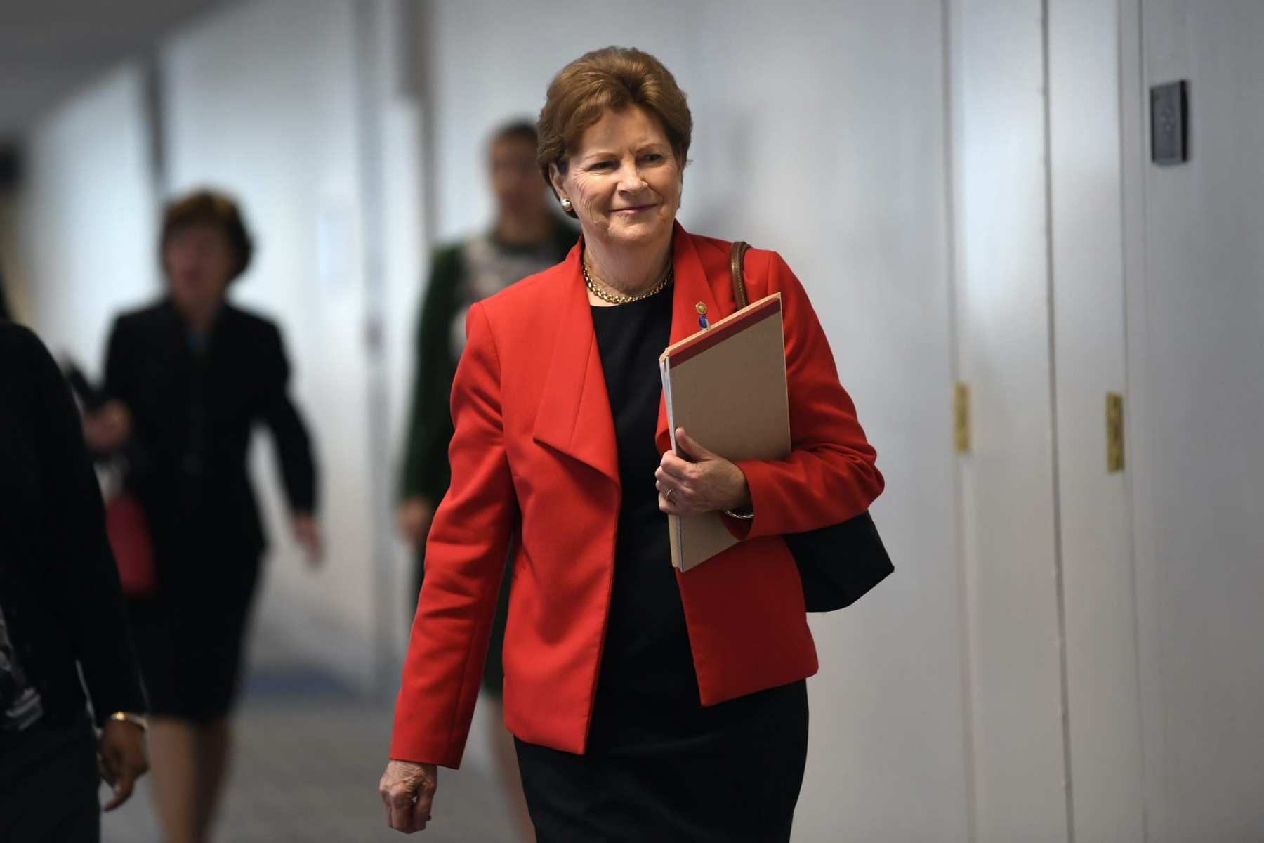 Sen. Jeanne Shaheen of New Hampshire, in a red blazer, arriving for a meeting on Capitol Hill in 2020.