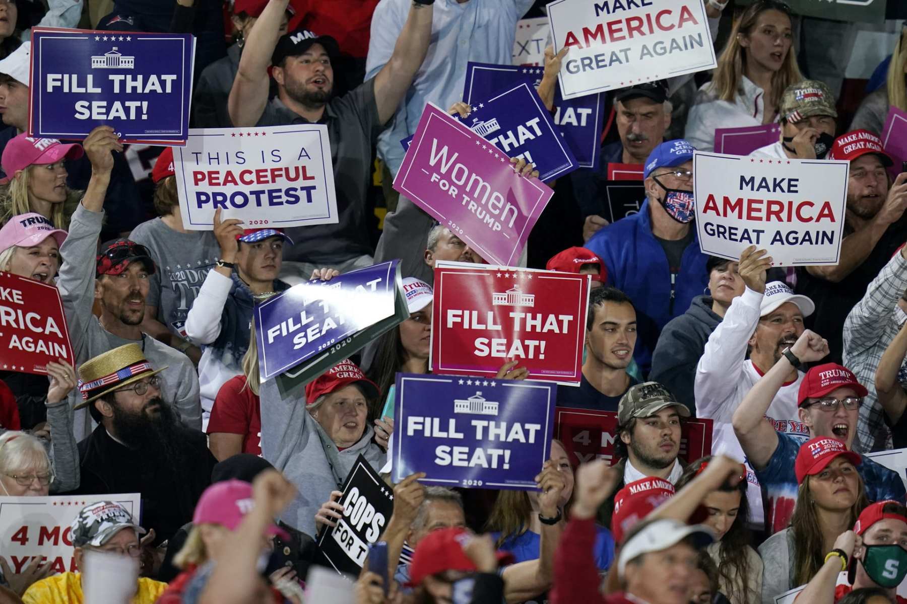 Supporters of President Donald Trump cheer as he speaks at a campaign rally, Tuesday, Sept. 22, 2020, in Moon Township, Pennsylvania.