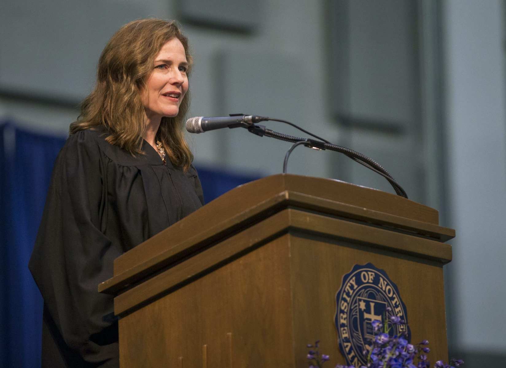 Amy Coney Barrett gives a speech at a podium.