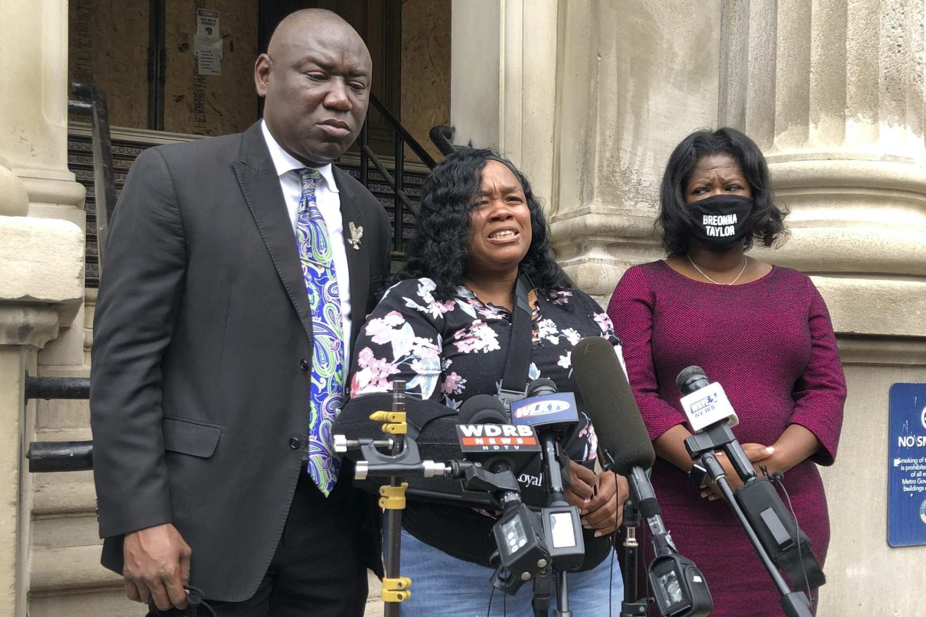 Tamika Palmer, mother of Breonna Taylor, stands in front of microphones addressing press.