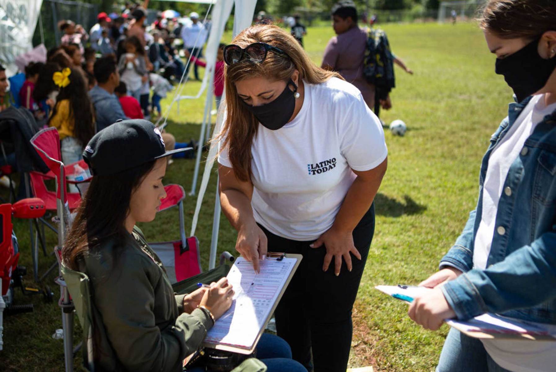 Sandra Amado Gomez and her daughter Aylen Agostina Gomez registers a woman to vote during halftime at the championship game of soccer on Sunday, Sept. 20, 2020 in Raleigh, NC. North Carolina is gearing up to be a swing state in the 2020 election and Latino voters will play a big part in the outcome.