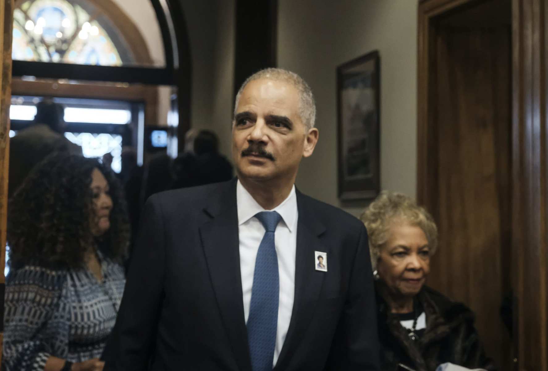 Former Attorney General Eric Holder arrives for a ceremony to unveil the new Gwen Ifill Black Heritage Commemorative Forever Stamp during a Postal Service ceremony at the Metropolitan African Methodist Episcopal Church, Thursday, Jan. 30, 2020, in Washington.