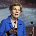 Elizabeth Warren speaks at a podium.