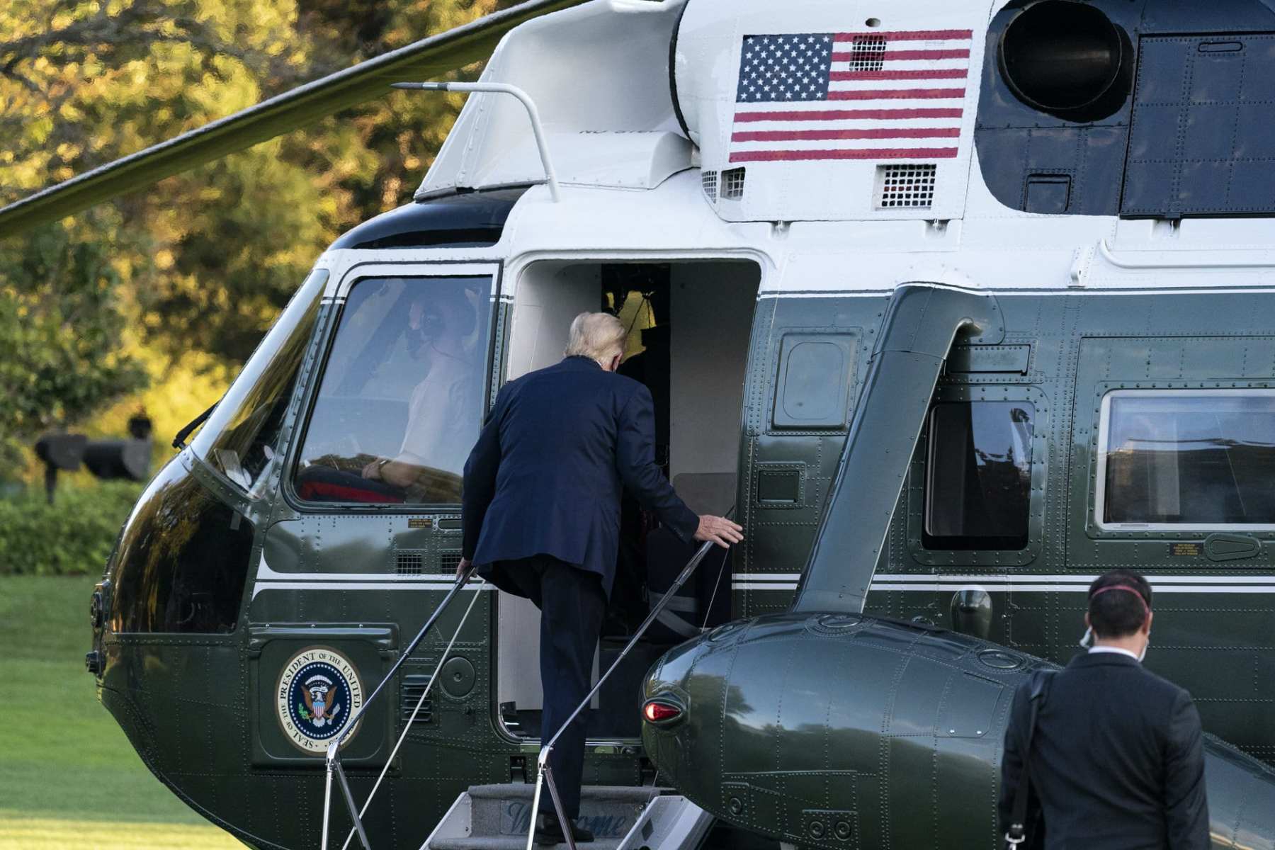 President Donald Trump boards Marine One as he leaves the White House to go to Walter Reed National Military Medical Center after he tested positive for COVID-19, Friday, Oct. 2, 2020, in Washington. (AP Photo/Alex Brandon)