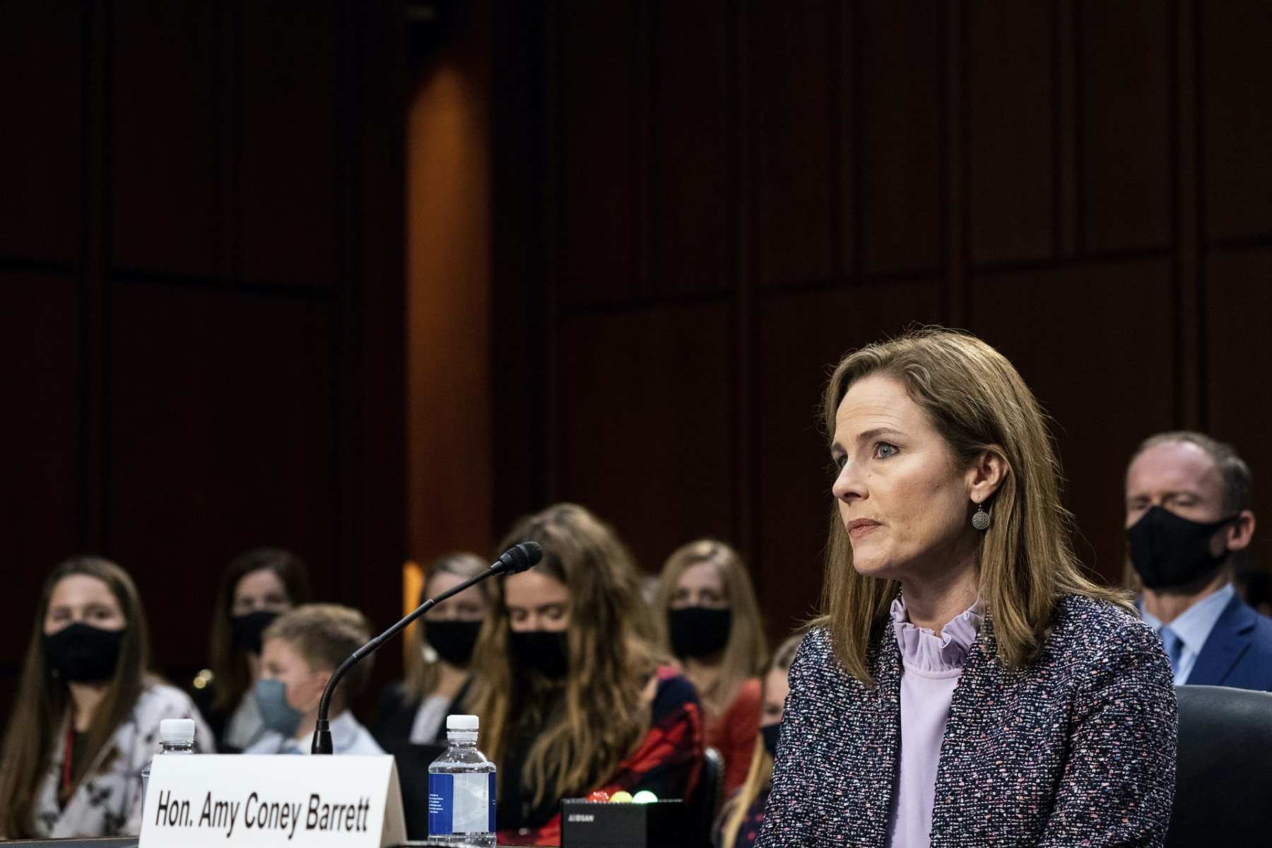 Amy Coney Barrett sits at a desk in front of the Senate Judiciary Committee.