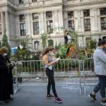 Voters in Philadelphia complete registration paperwork while waiting outside of Philadelphia City Hall for early voting on October 27, 2020.