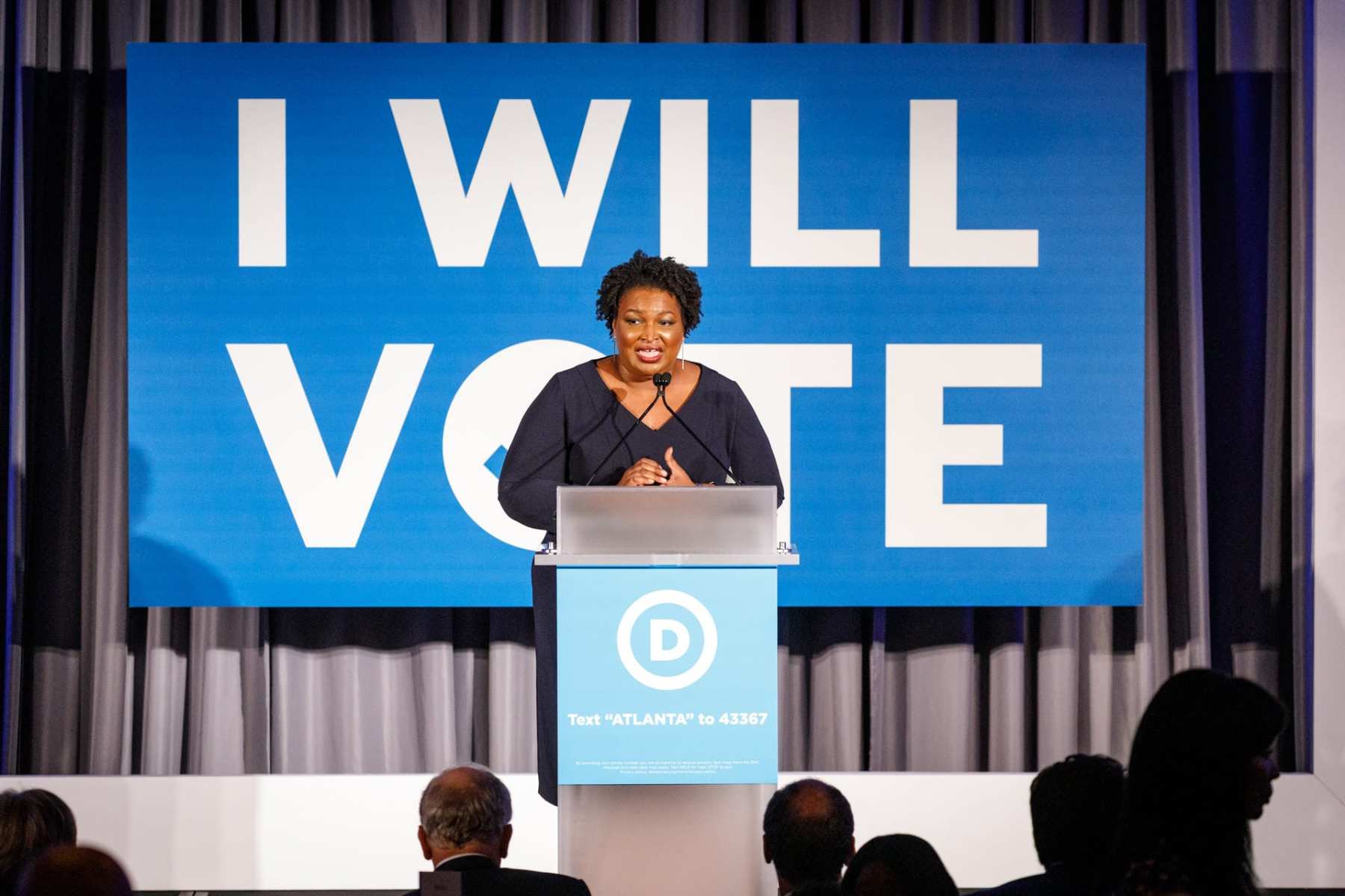 Stacey Abrams speaks at a podium.