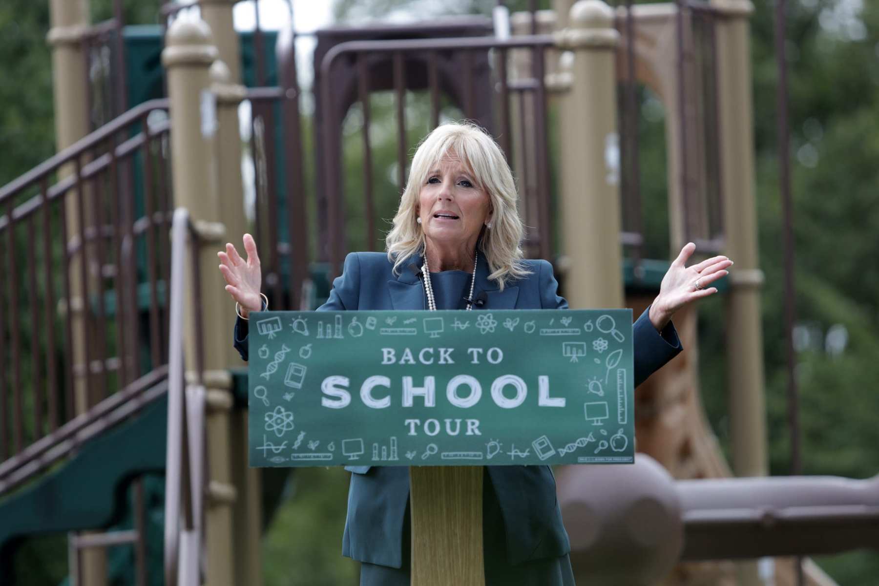 Jill Biden speaking at a podium at a playground.