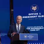 Joe Biden stands at a podium.