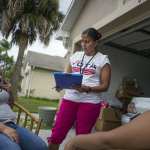 Soraya Marquez, the state coordinator for Mi Familia Vota and her crew hit a Puerto Rican neighborhood trying to get Latinos to register to vote in the 2016 presidential election on July 24, 2015 in Kissimmee, FL. Jeamy Ramirez gets a young girl (18) to register to vote in a Puerto Rican neighborhood in Kissimmee. (Photos by Charles Ommanney/The Washington Post via Getty Images)