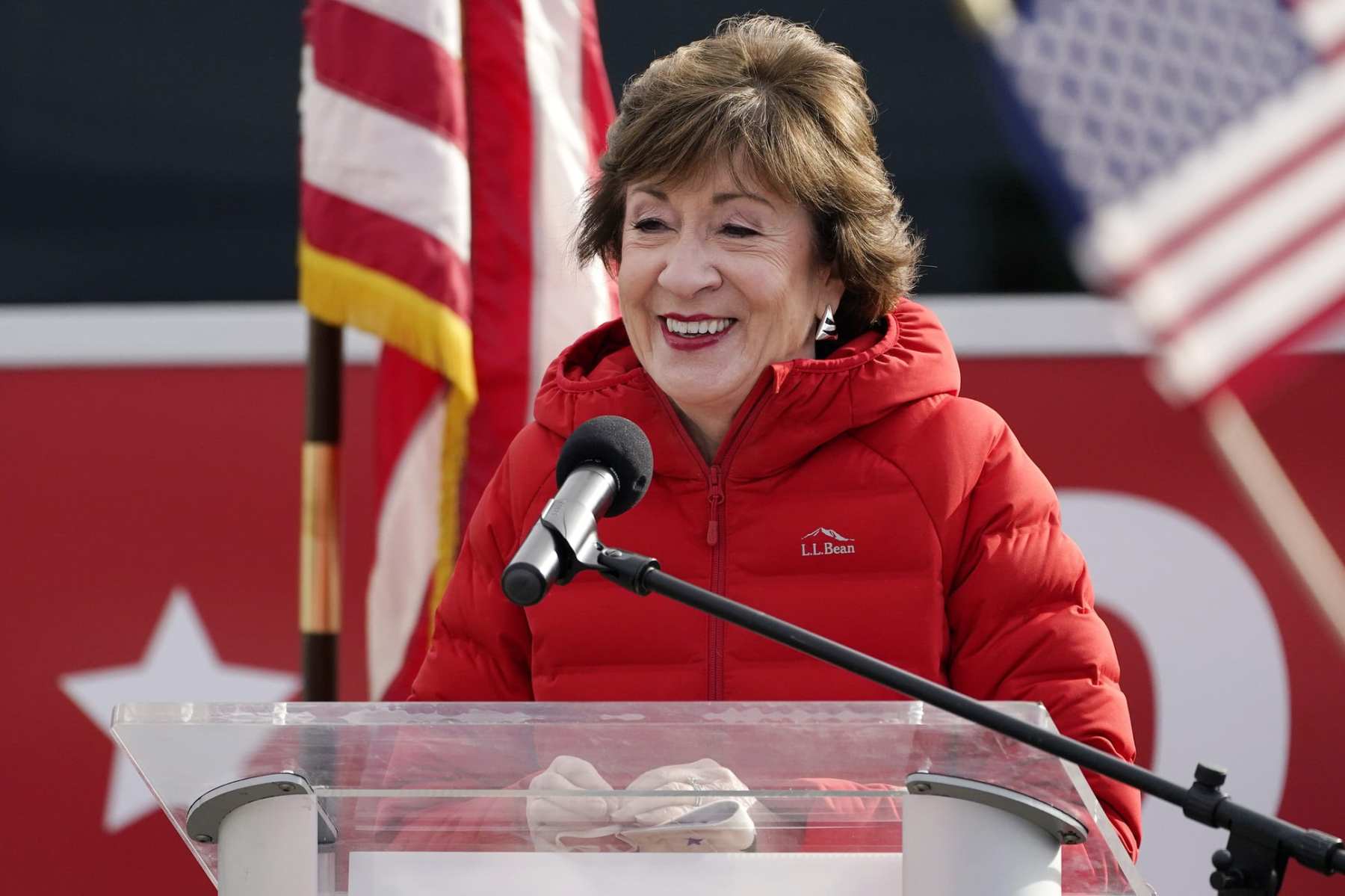 Susan Collins speaks at a podium.