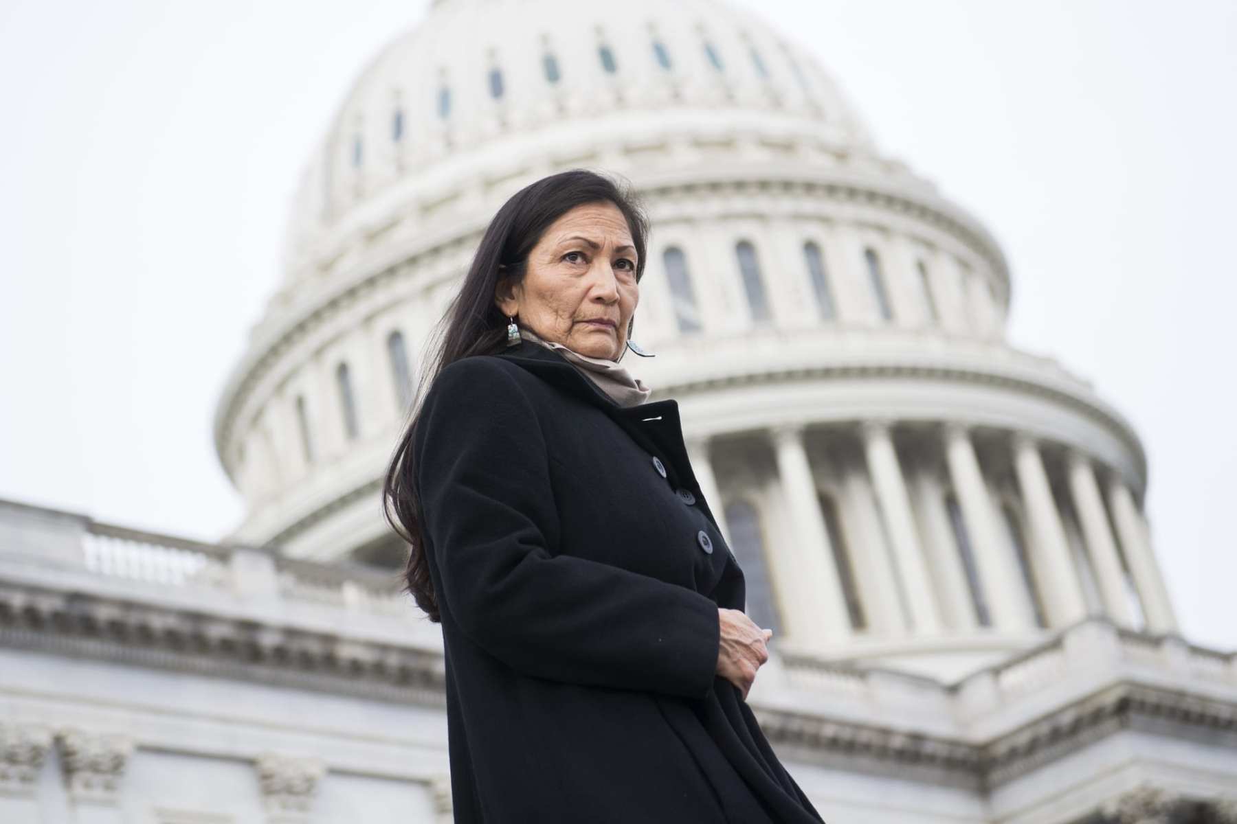 DEb Haaland standing in front of the U.S. Capitol building.