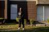 Shanta Scott, 41, stands in the courtyard of her New Orleans apartment complex in a sweatshirt memorializing her late son Jacé.