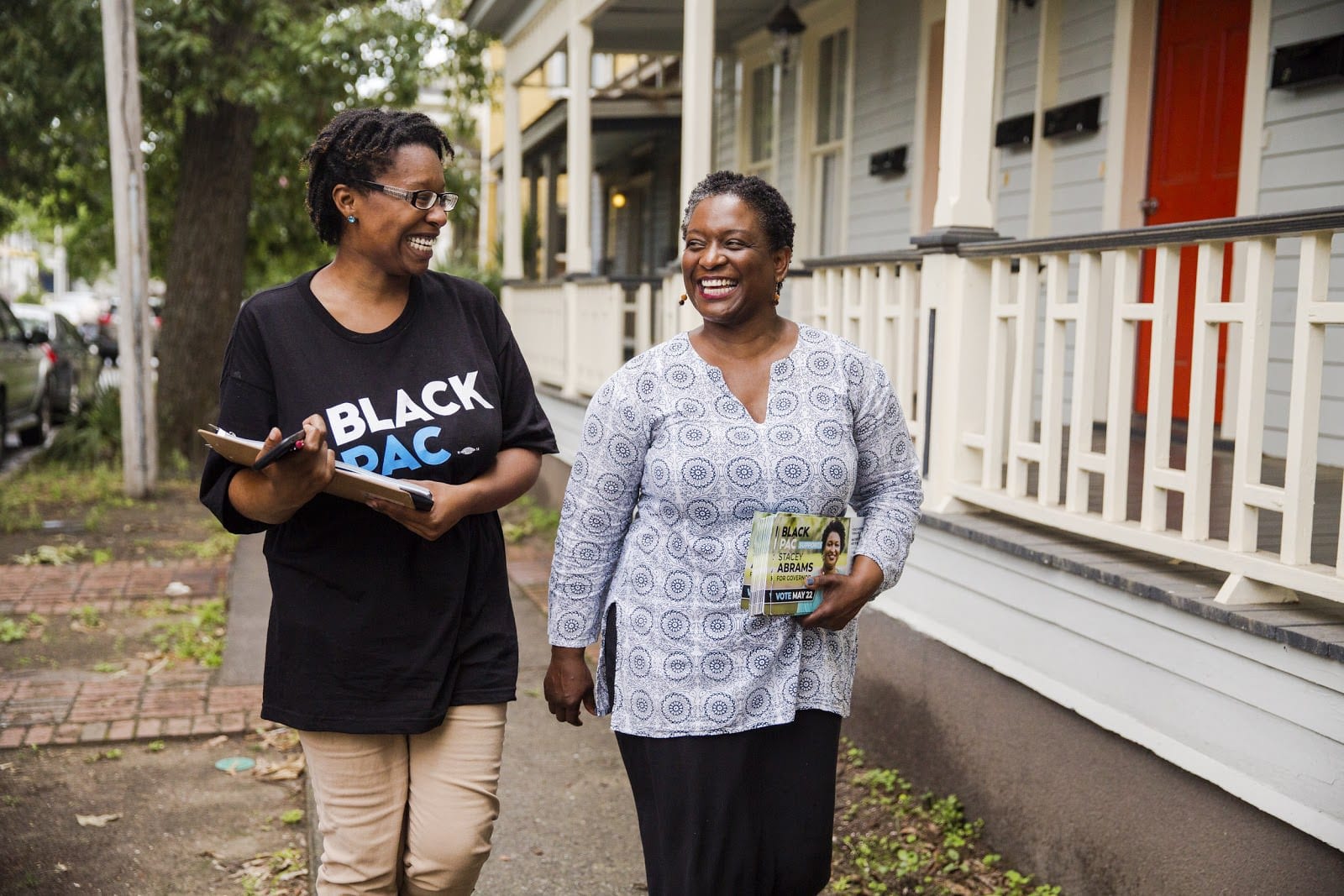 Adrianne Shropshire, executive director of BlackPAC, walking with a canvasser.