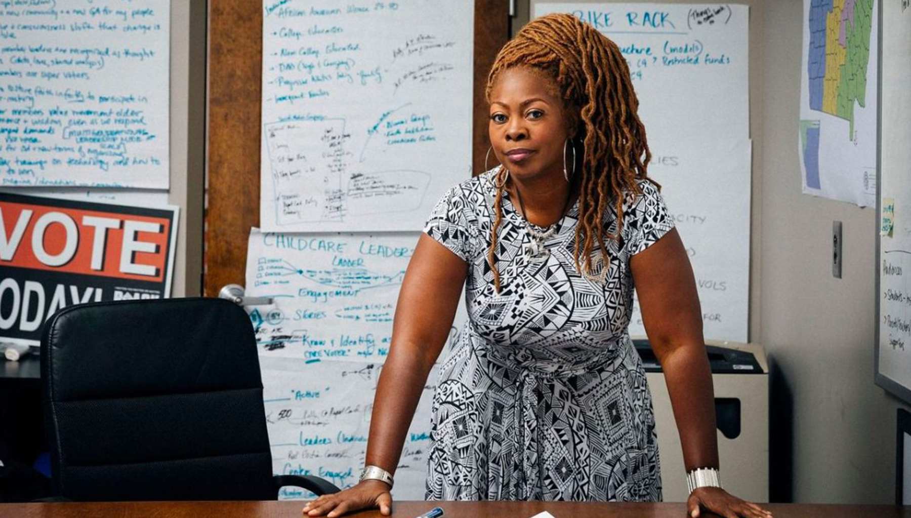 Latosha Brown standing behind a desk.