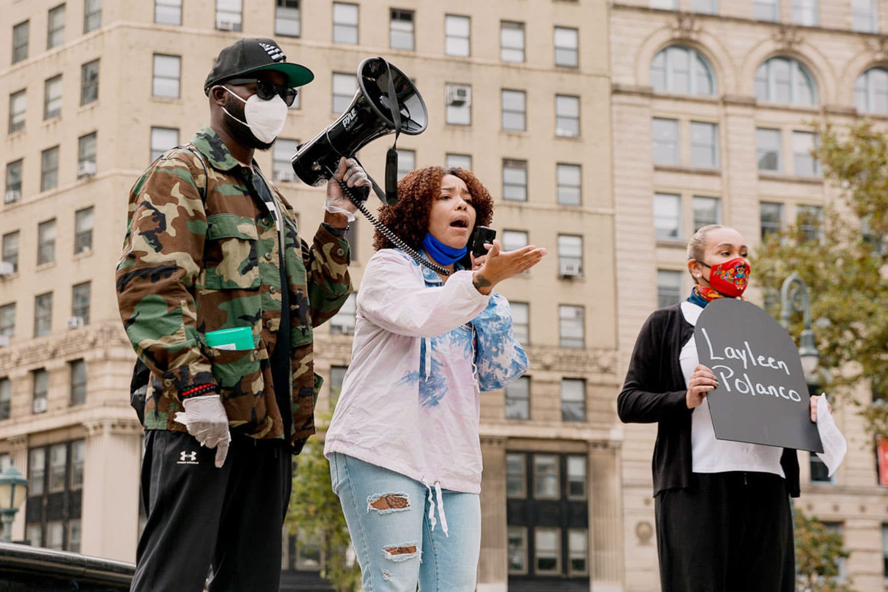 A woman speaking at a protest.