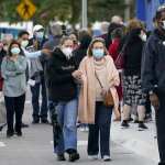 People line up at Jackson Memorial Hospital to receive the COVID-19 vaccine.