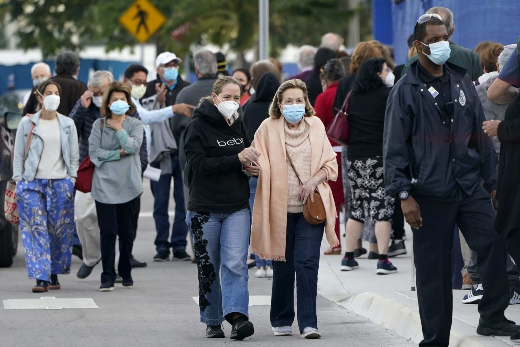 People line up at Jackson Memorial Hospital to receive the COVID-19 vaccine.