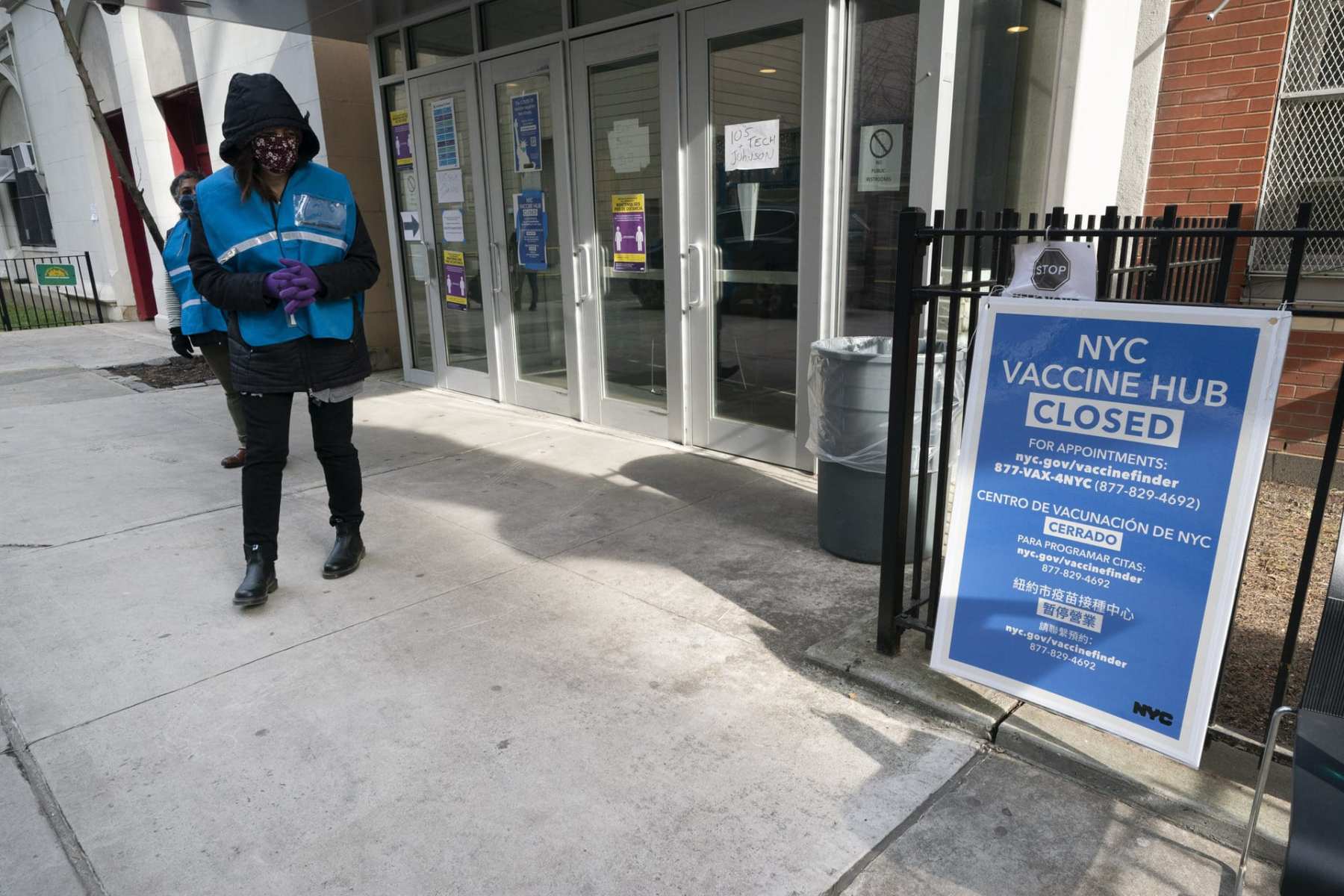 A person standing outside a close vaccination center.