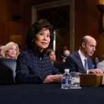 U.S. Secretary of Transportation Elaine Chao sitting at a table for a hearing.