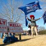 WOODSTOCK, GA - DECEMBER 29: Gary White waves Trump flags during a Senate Firewall campaign rally for Sen. Kelly Loeffler (R-GA) at The Park at City Center on December 29, 2020 in Woodstock, Georgia. Loeffler faces Democratic Senate candidate Raphael Warnock in the runoff election that will determine control of the U.S. Senate. With a week until the January 5th runoff election, candidates continue to campaign throughout Georgia. (Photo by Jessica McGowan/Getty Images)