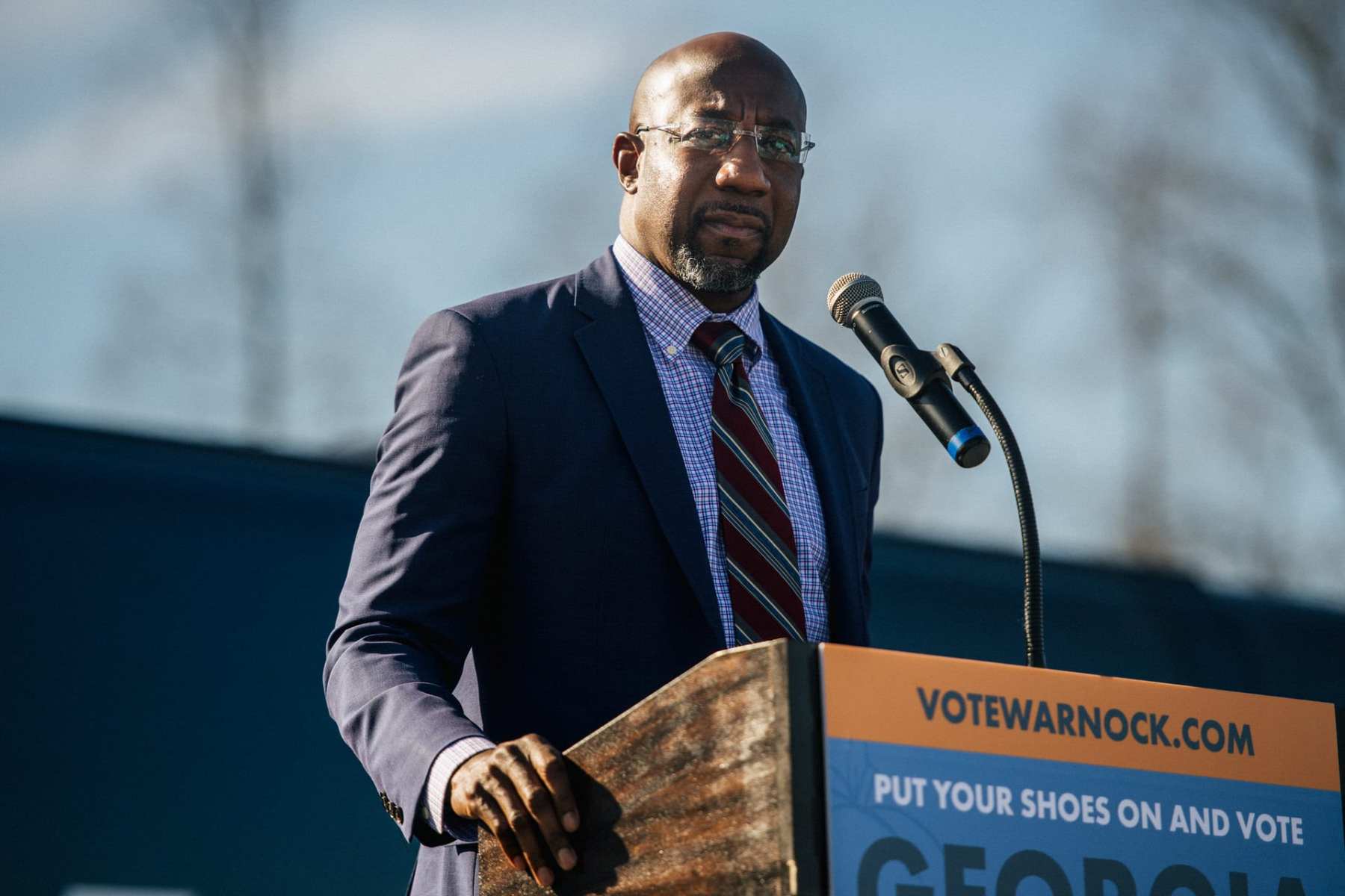 Raphael Warnock speaking at a podium.