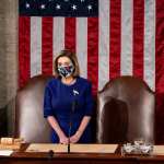 House Speaker Nancy Pelosi waits at the podium in a joint session of Congress.