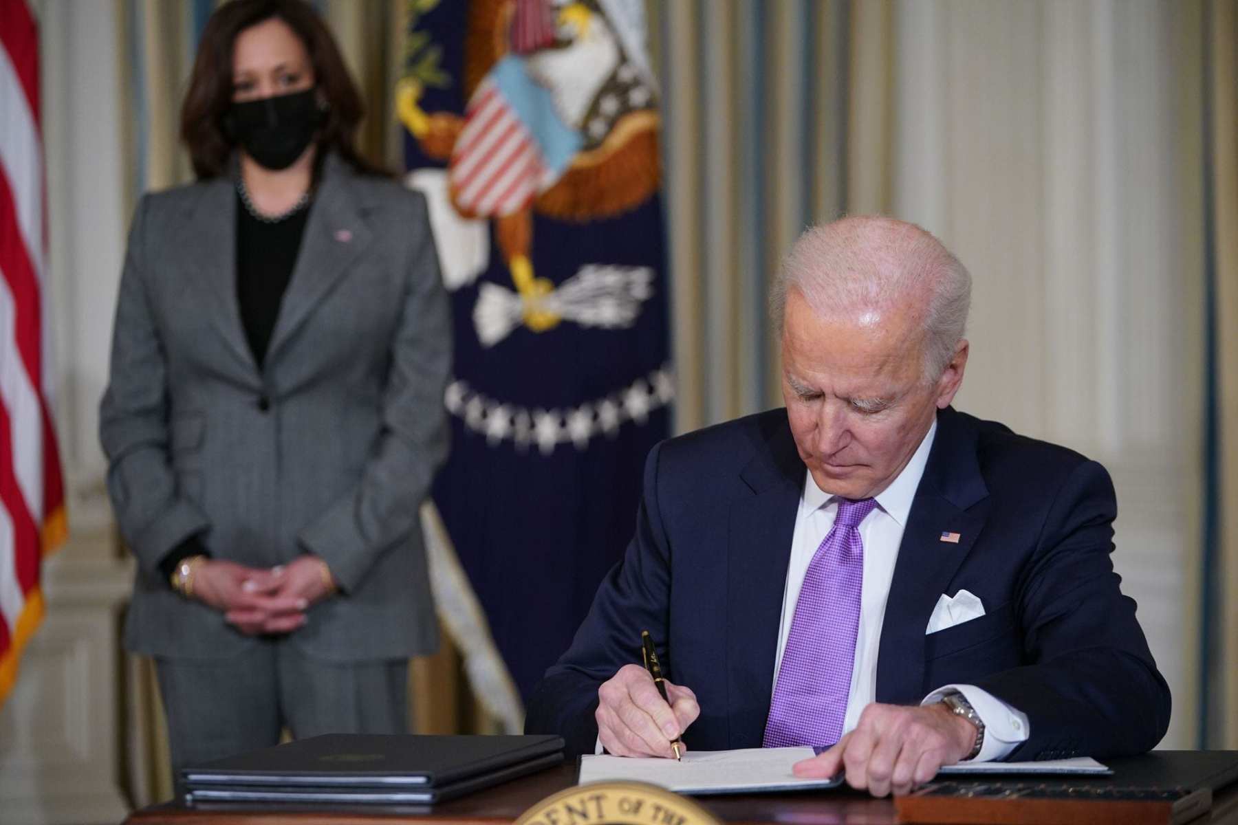 Joe Biden signs executive orders.