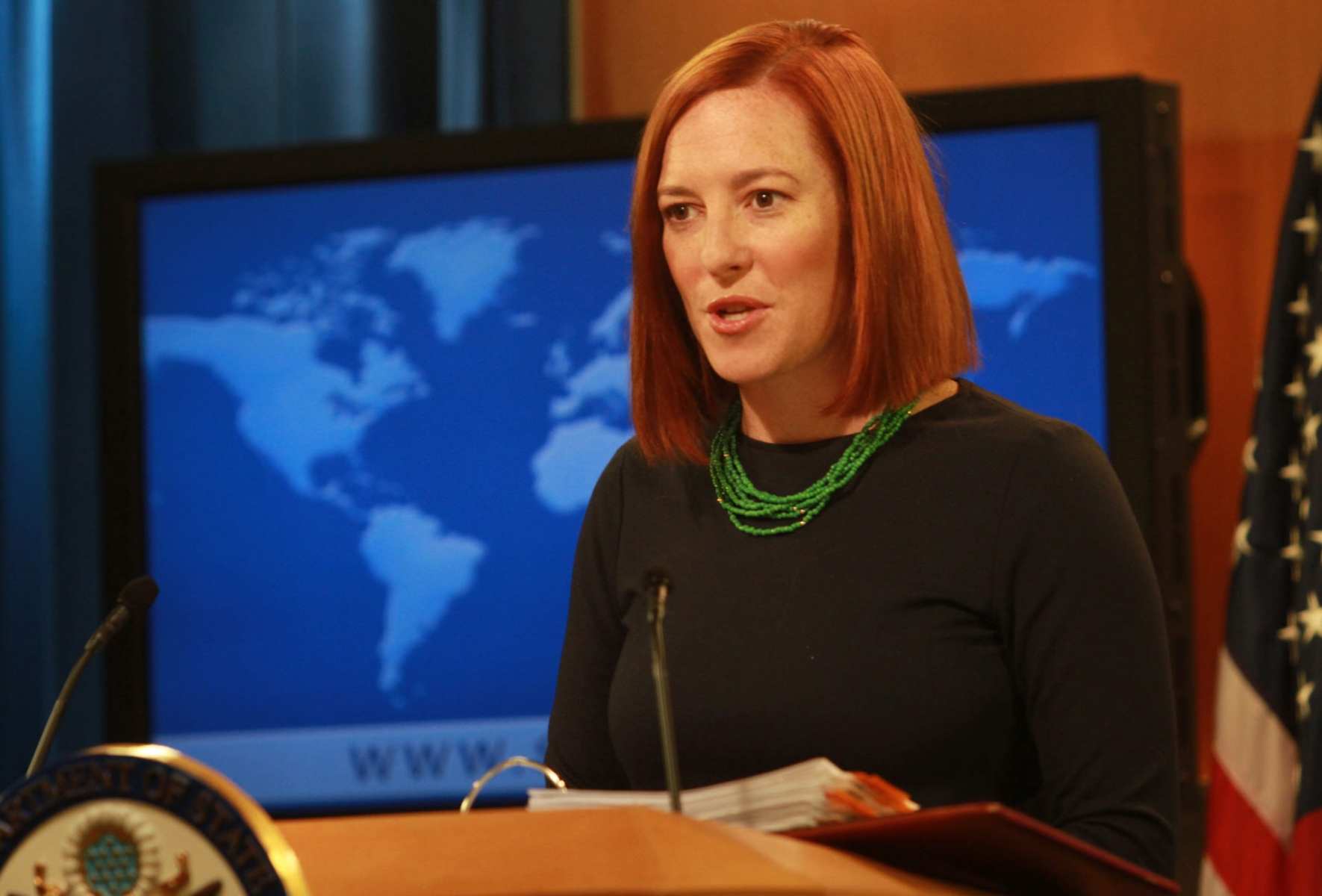 Jennifer Psaki speaks to journalists from a podium.