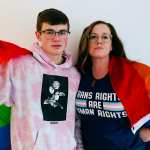 Jaime Gabrielli and her son Justin draped in an LGBTQ flag.