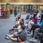 A photo of Katie Porter speaking to middle school students.