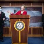 Sen. Elizabeth Warrens speaks from a podium at a news conference at the Capitol..