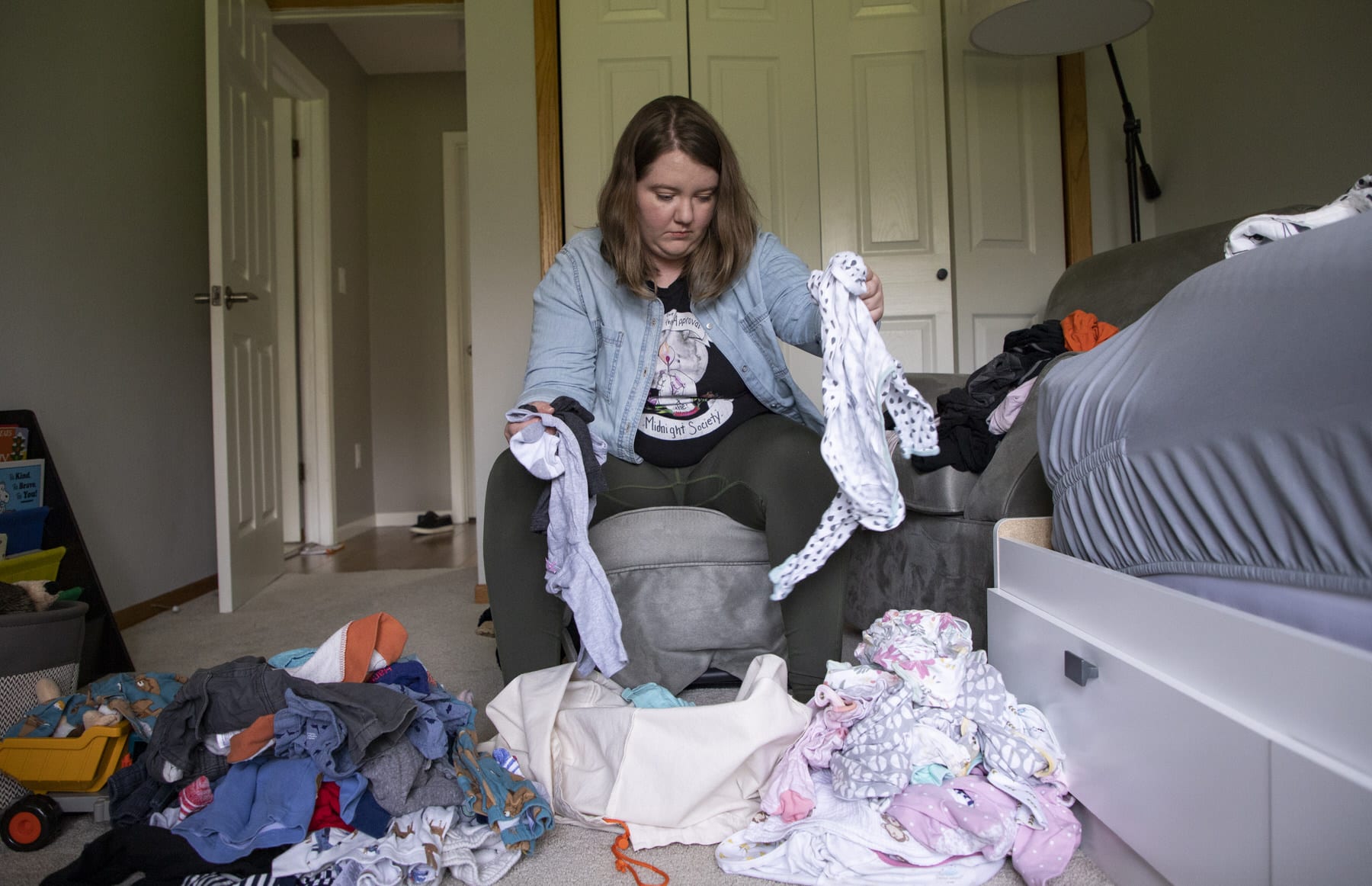 A mother sorts through laundry.