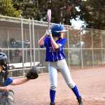 Eliza Schnitzer at bat on a baseball field.