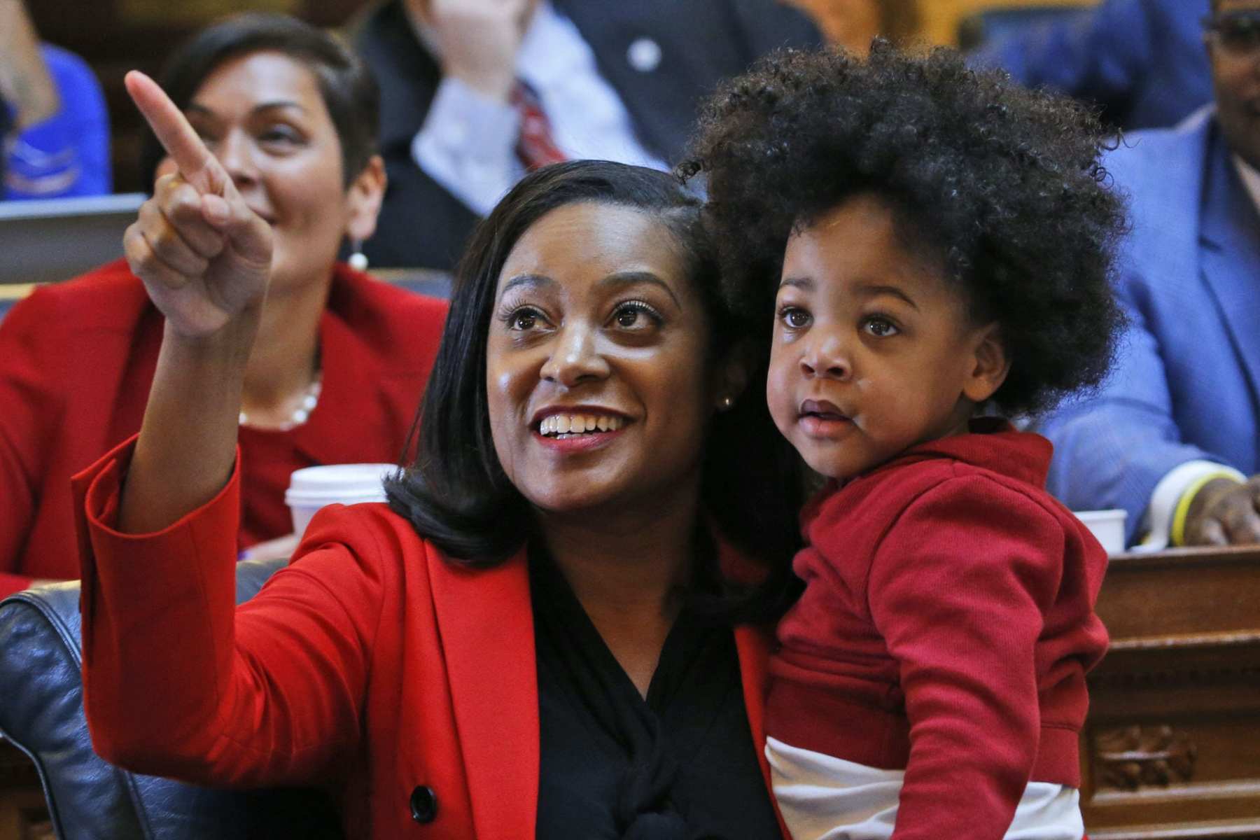 Jennifer Carroll Foy holds her baby on the floor of the Virginia House.