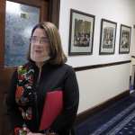 Alaska state Sen. Lora Reinbold, an Eagle River Republican, speaks to reporters in a hallway.