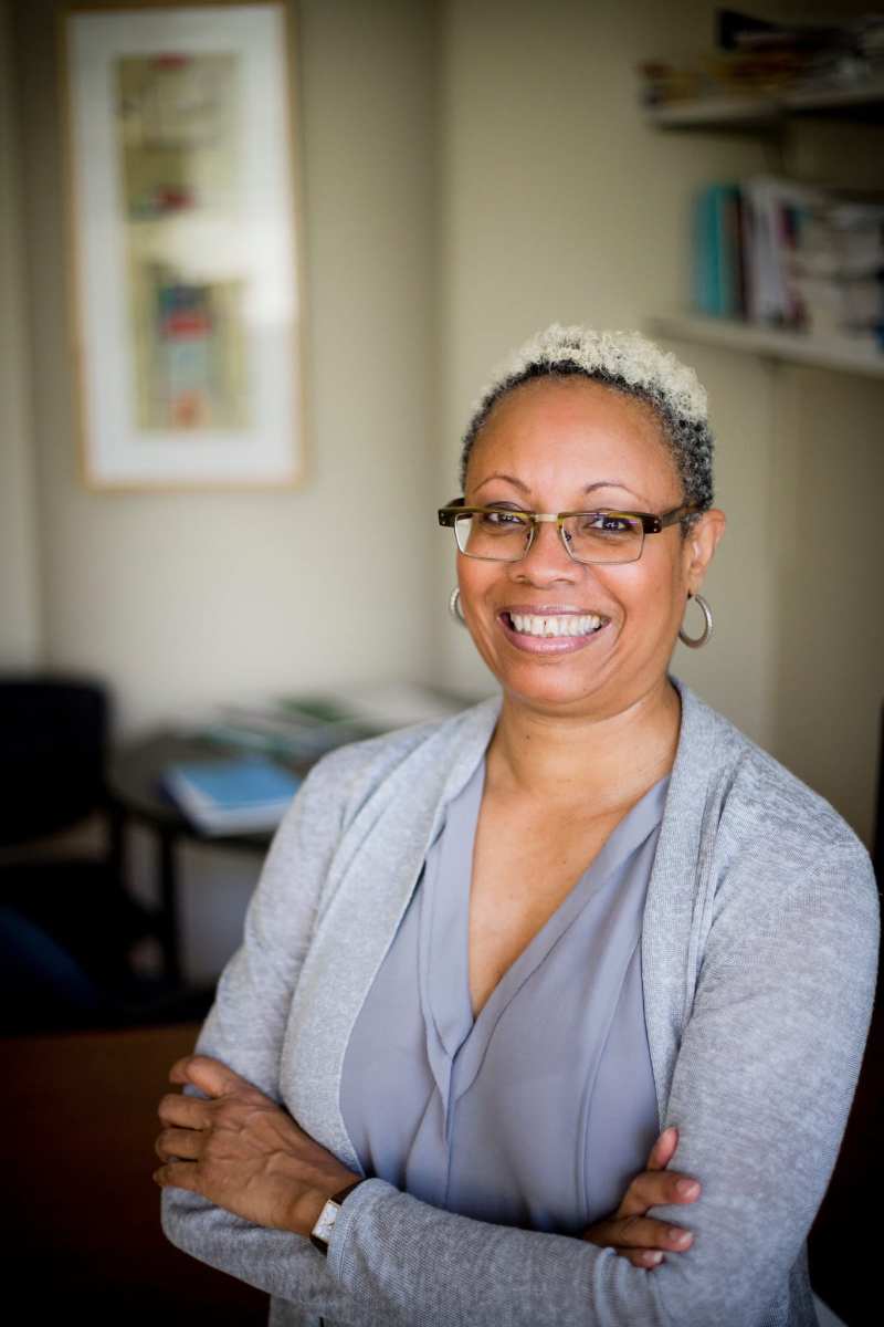 Dorothy Brown, professor at Emory University and author of The Whiteness of Wealth, standing posed, smiling, in a pastel blouse and cardigan.