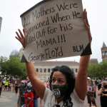 Shellee Mendes, a mother of three, raised her sign during the March Like A Mother for Black Lives rally at Copley Square in Boston, MA on June 27, 2020. Organizers say the peaceful, family-friendly event was created in response to the murders of George Floyd, Breonna Taylor, and Ahmaud Arbery to empower mothers to stand in solidarity against racism and anti-blackness while demanding radical systemic change.