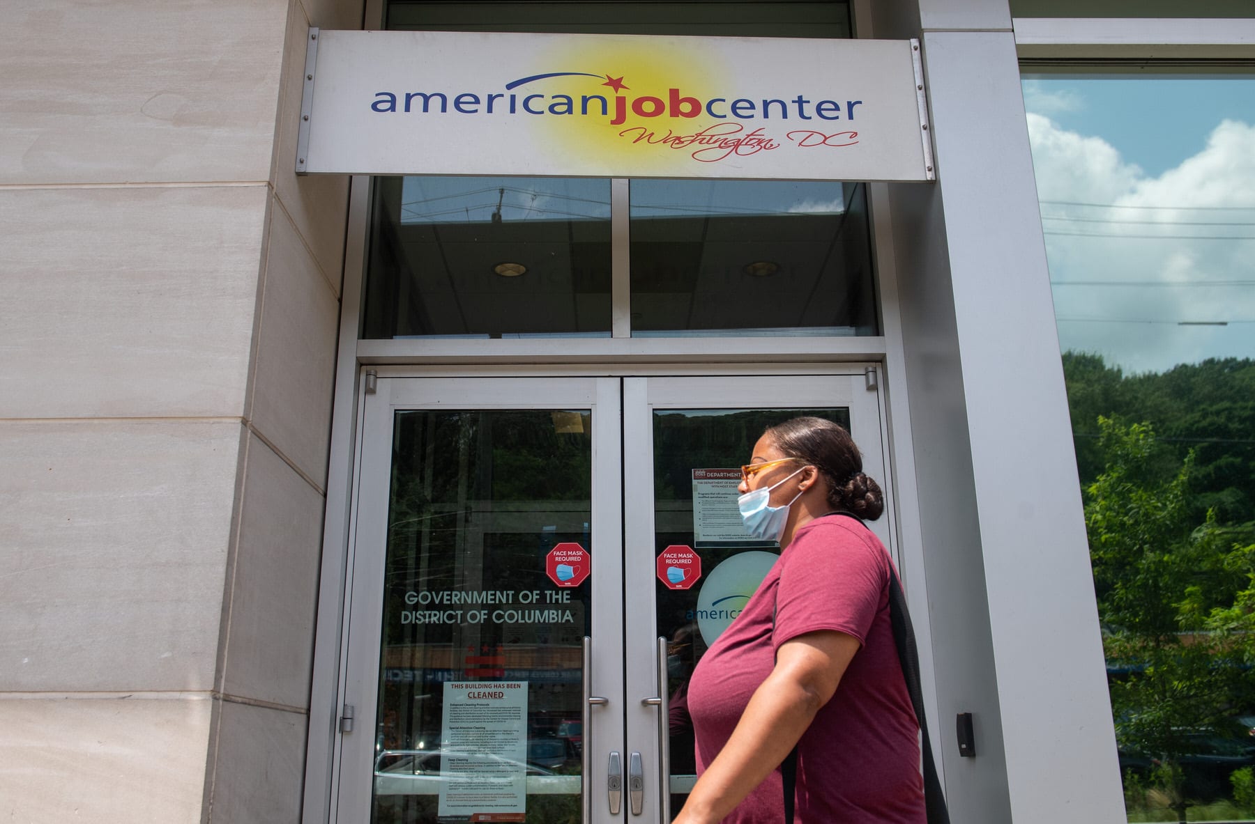 A woman walks past the the DC Department of Employment Services American Job Center.