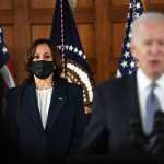 Vice President Kamala Harris stands while President Joe Biden speaks