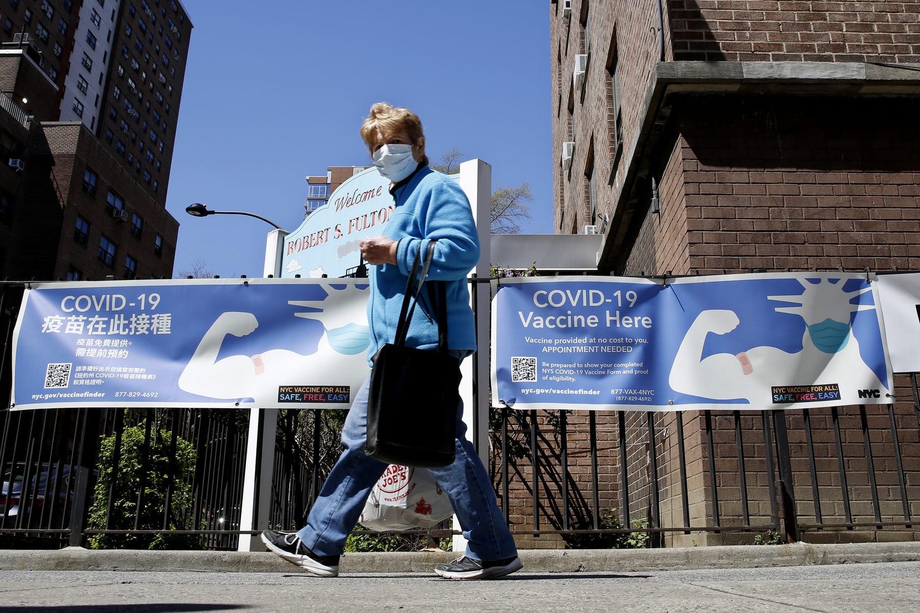 A woman walks near a Covid-19 Vaccination Center in New York City.