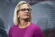 Sen. Kyrsten Sinema, D-Ariz., conducts a news conference.