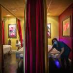 A woman makes a bed in a health spa.